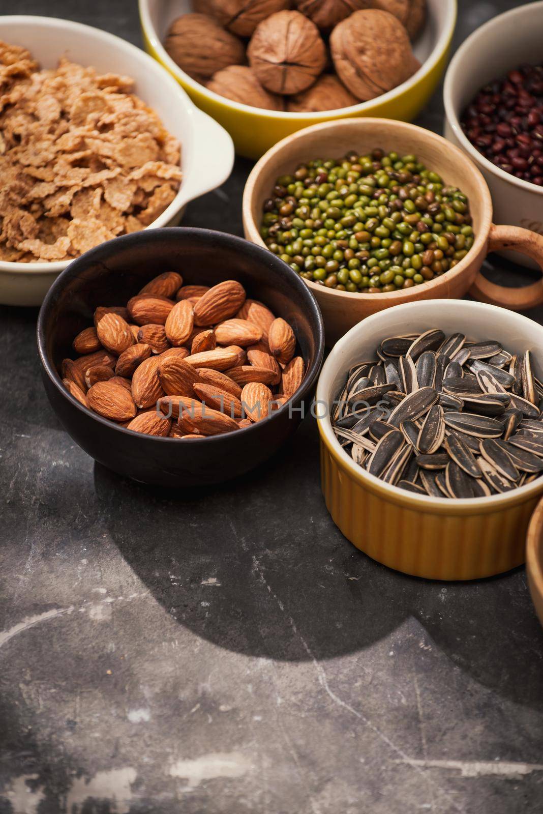 Different kinds of nuts in bowls.