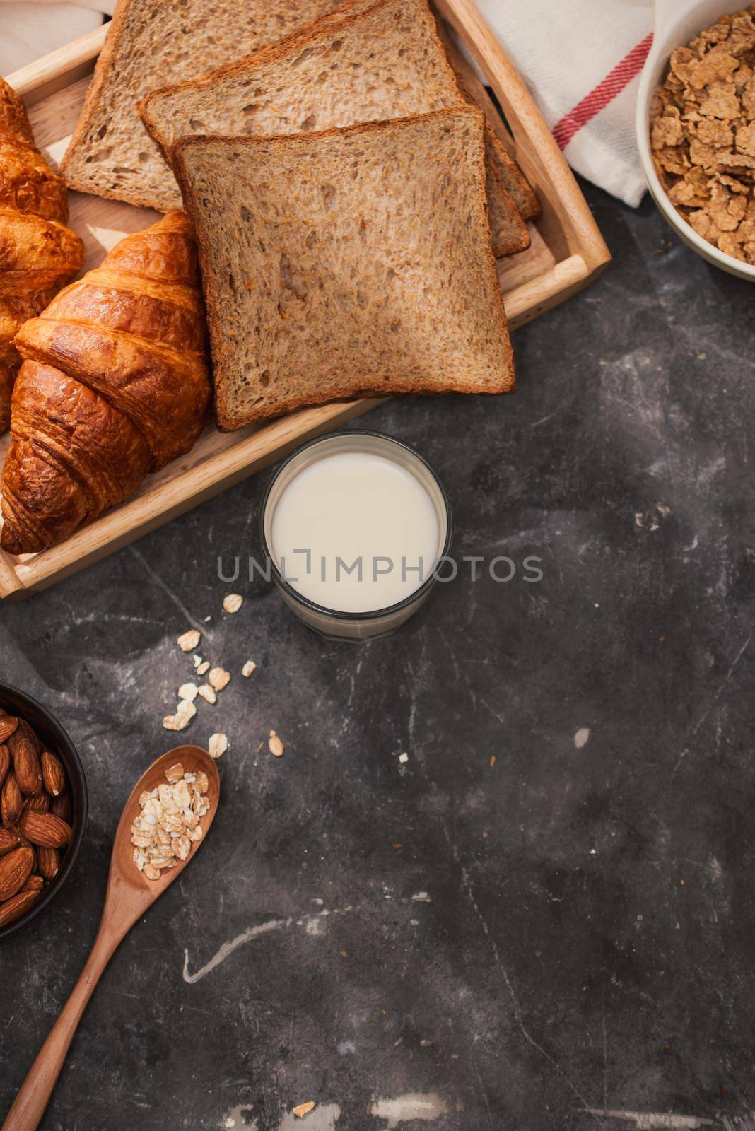 Breakfast with toast and croissant. milk in a glass bottle. Good start to the day. Good morning