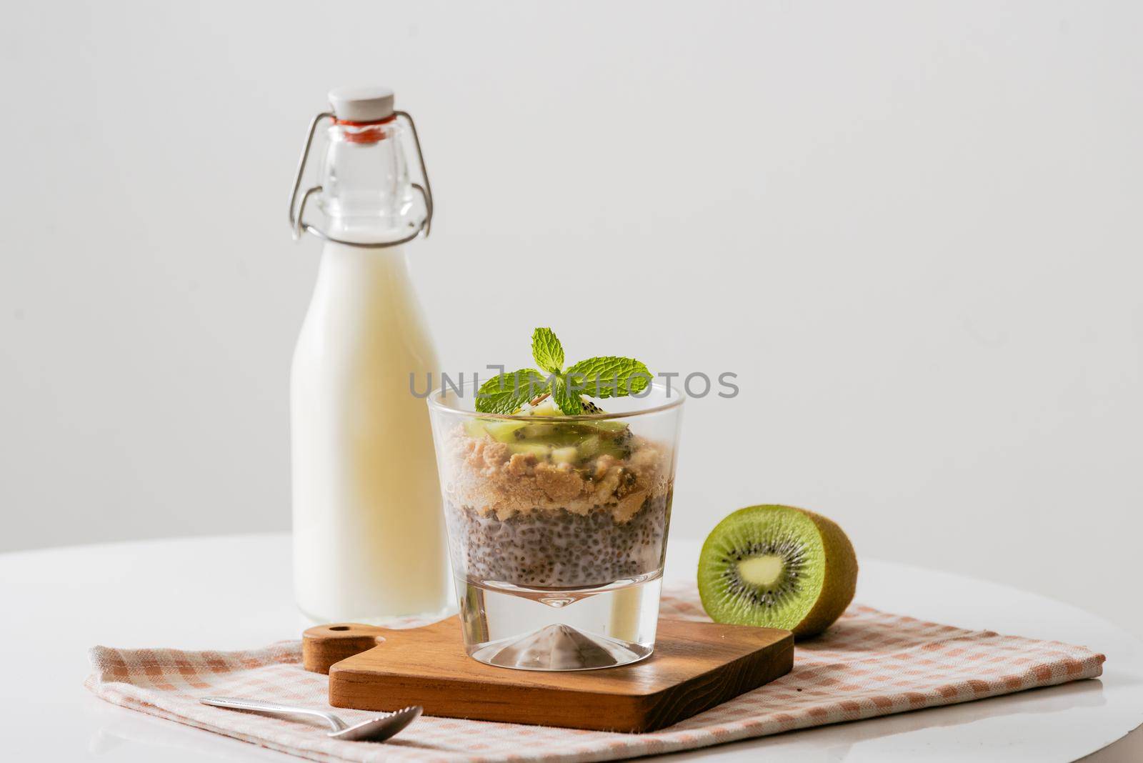 Healthy breakfast with yogurt, nut, kiwi and chia seeds. Bowl of fresh fruit.