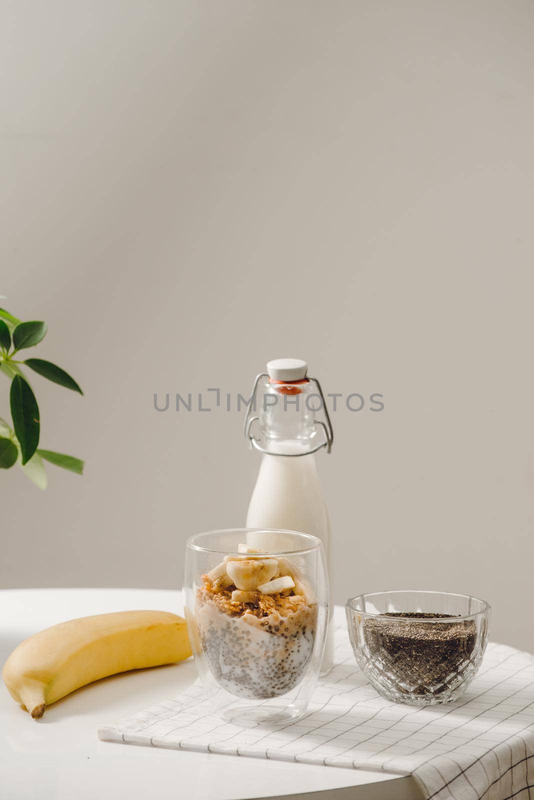 Banana chia yogurt pudding decorated with ripe sliced banana and peanuts