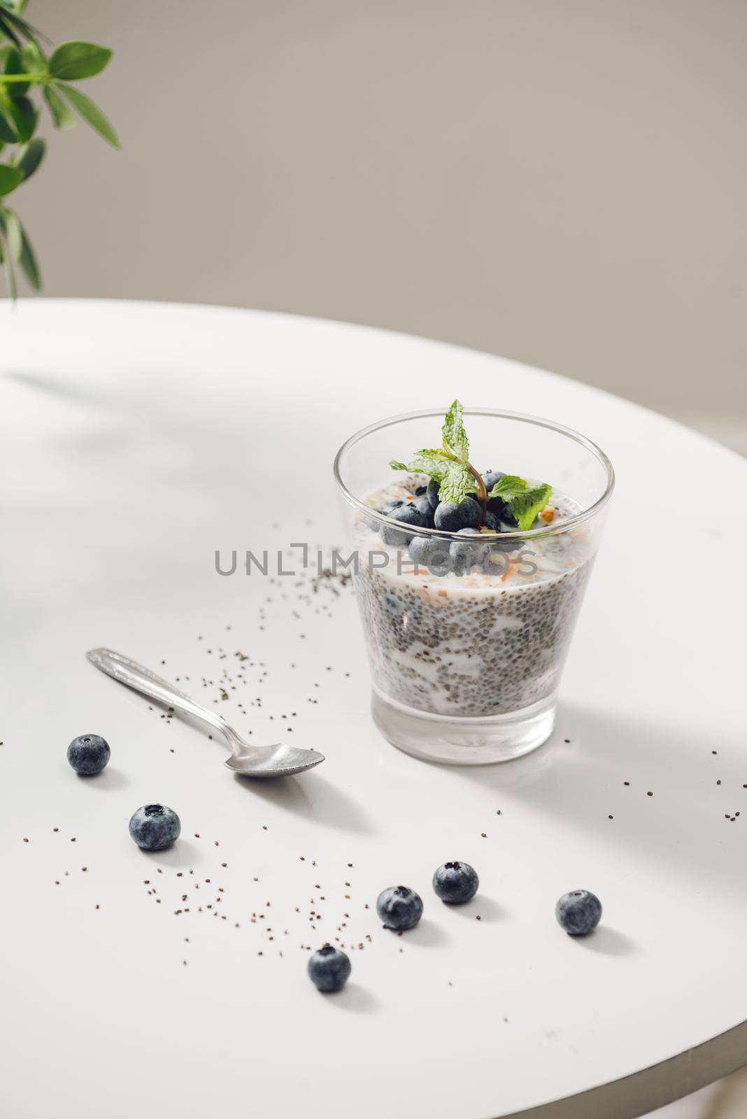 Healthy breakfast or morning snack with chia seeds vanilla pudding and berries on wooden background, vegetarian food, diet and health concept
