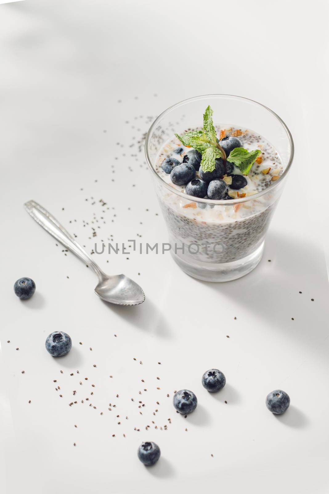 Healthy breakfast or morning snack with chia seeds vanilla pudding and berries on wooden background, vegetarian food, diet and health concept