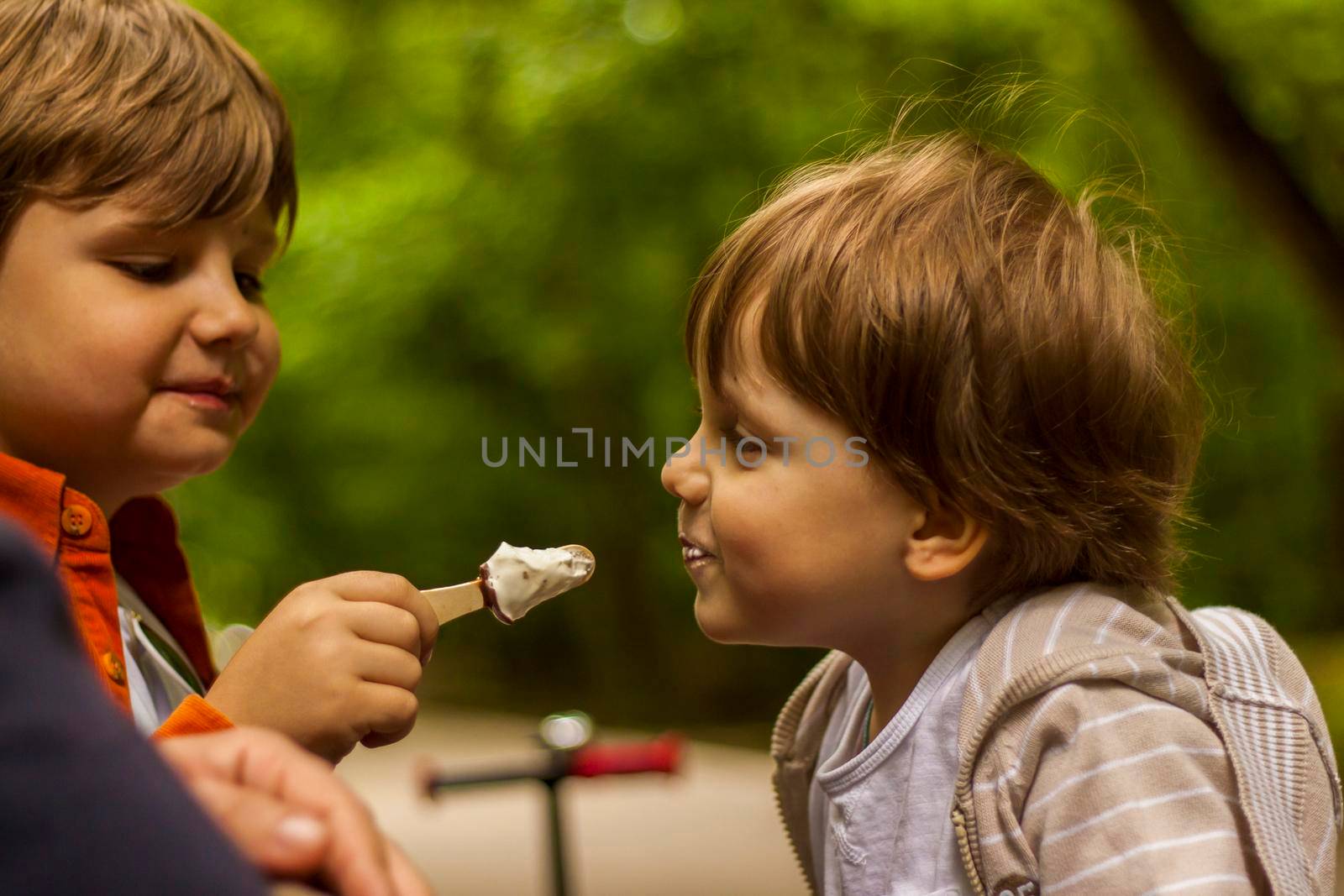 Children have fun in the park. Walk, play and eat ice cream. Emotions, joy. 