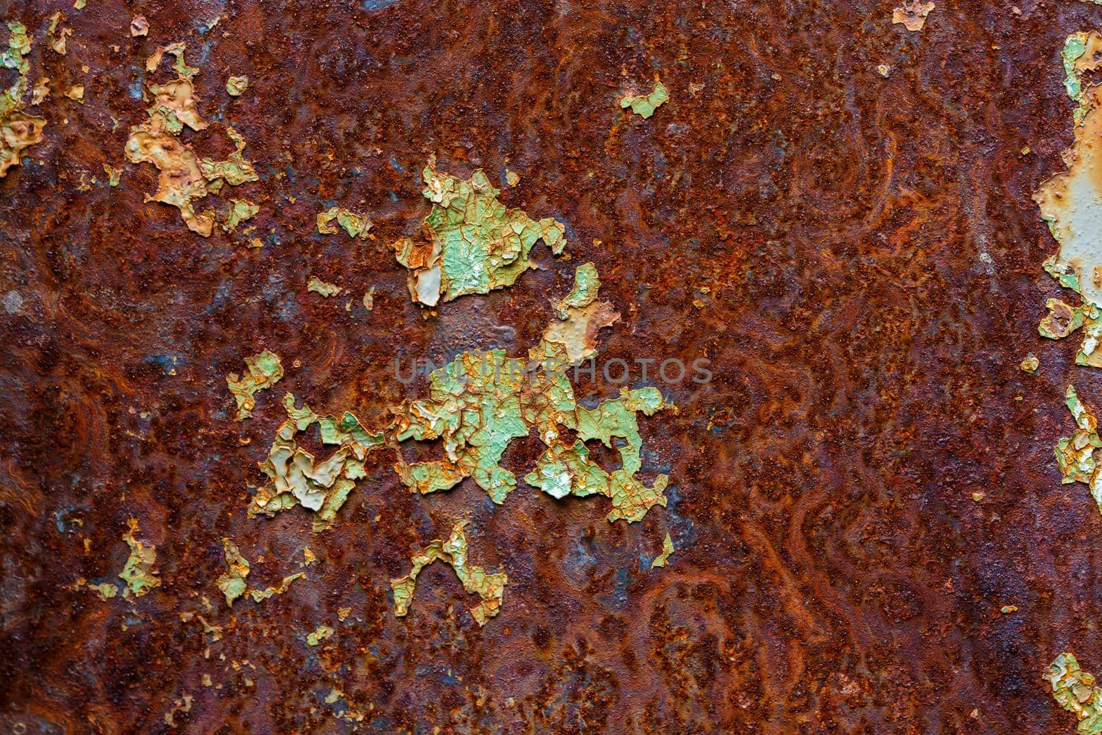 artisticly rusted flat iron surface with leftowers of peeled off paint.