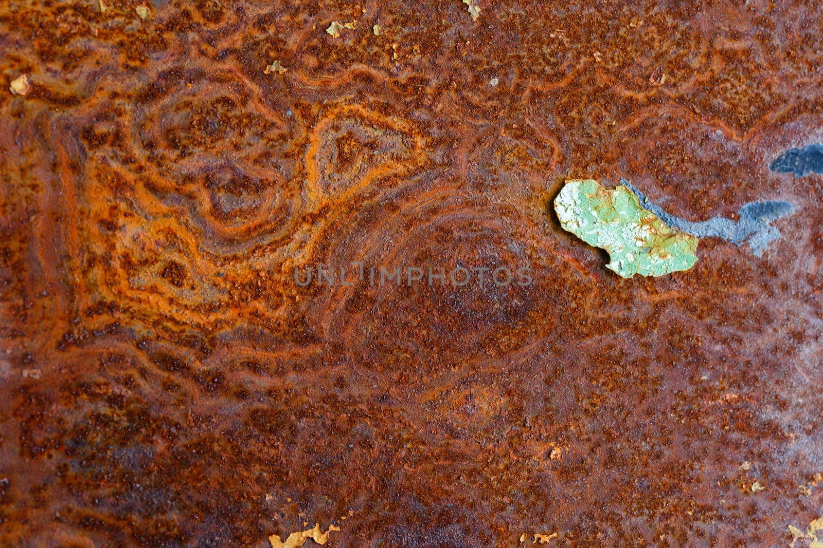 artisticly rusted flat iron surface with leftowers of peeled off paint.