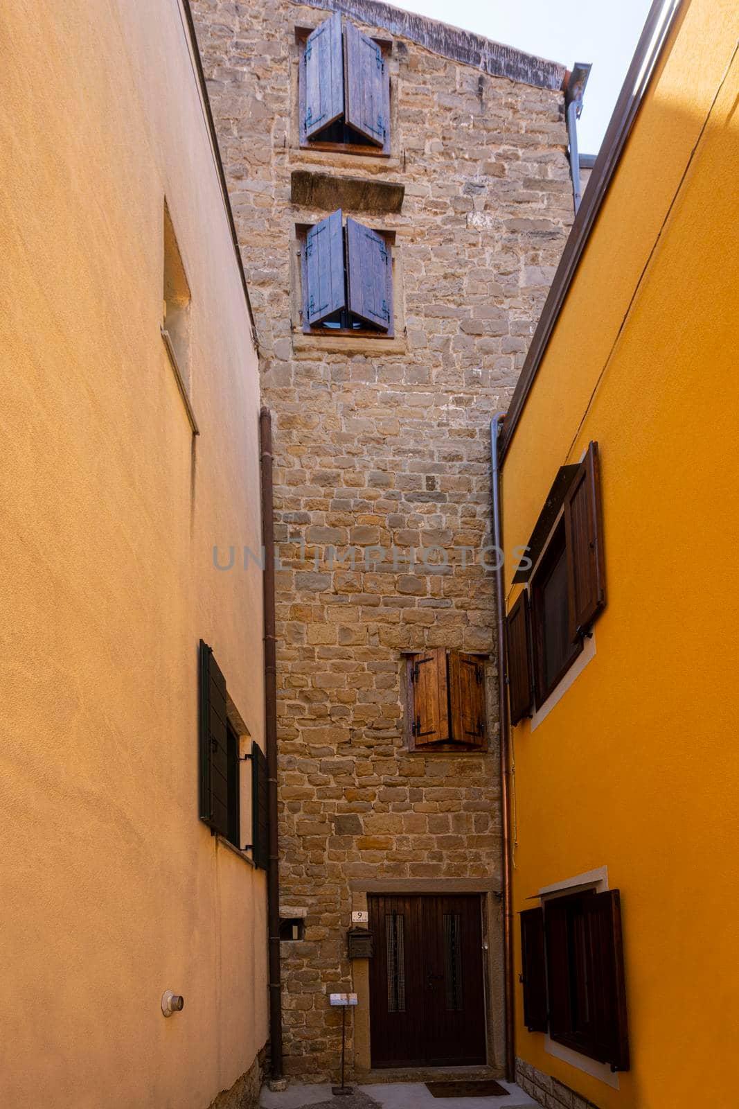 Muggia, Italy. June 13, 2021. the view of El Tor, the only remaining medieval tower from the original nine protruding from the tower walls.