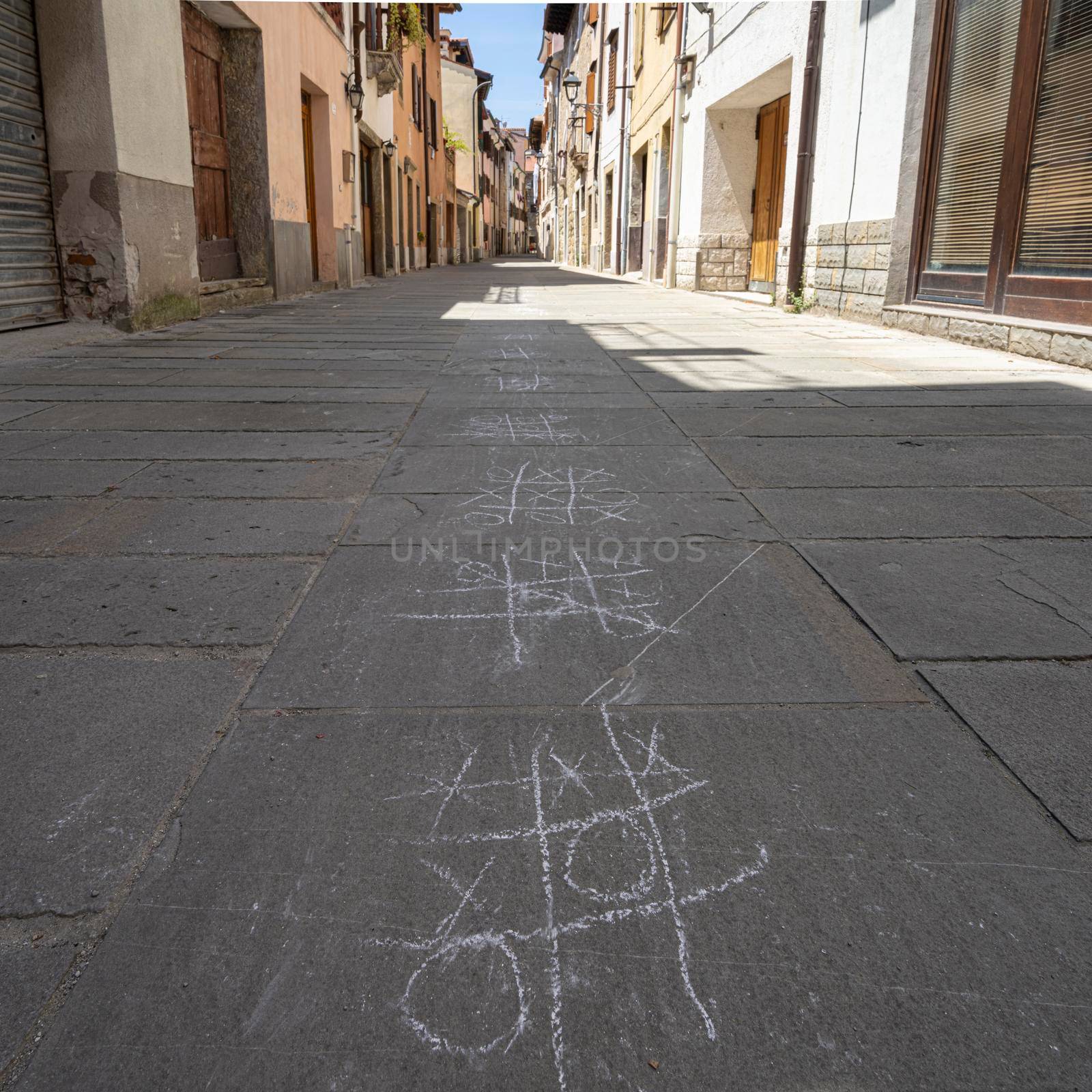 Muggia, Italy. June 13, 2021. the tic-tac-toe game drawn with chalk on the pavement of a narrow street in the town center