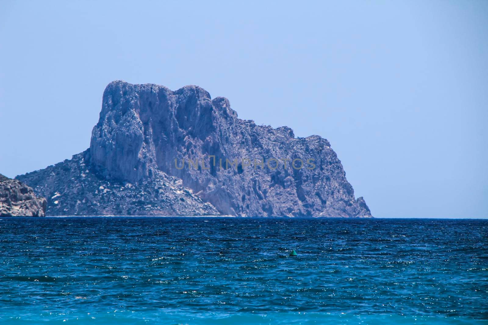 Beautiful Cap Negret beach and rock of Calpe in the background on a sunny day of Spring in Altea, Alicante, Spain