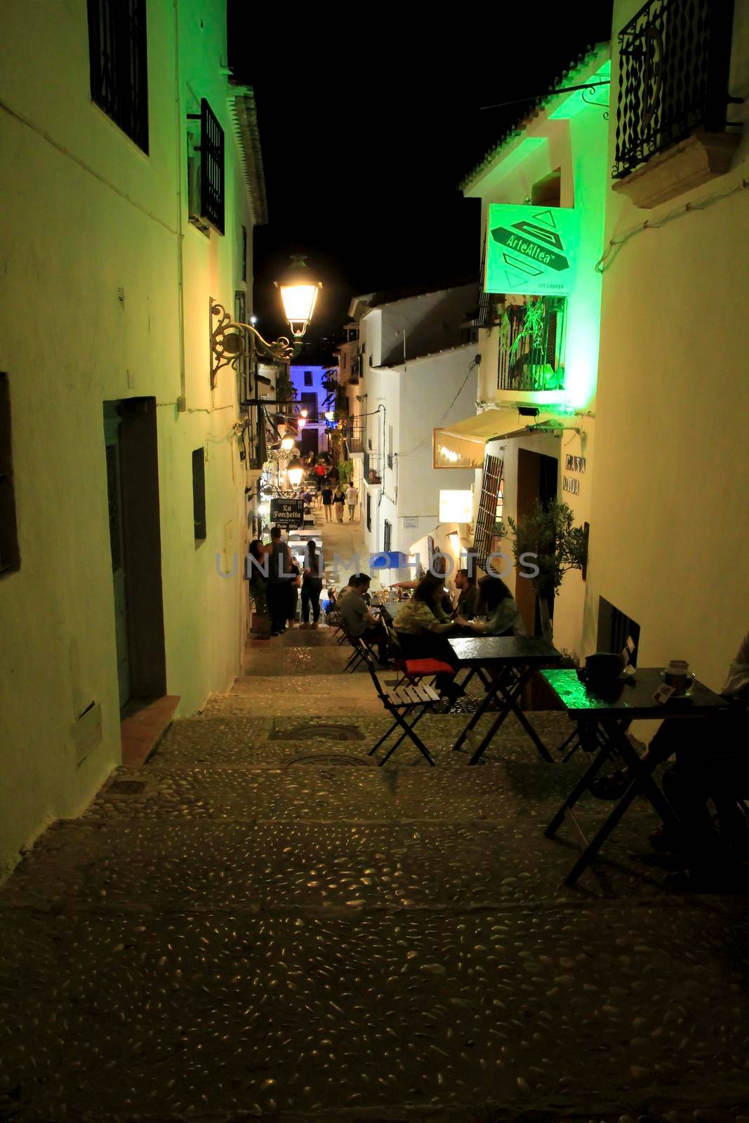 People enjoying in bar terraces in Altea at night by soniabonet
