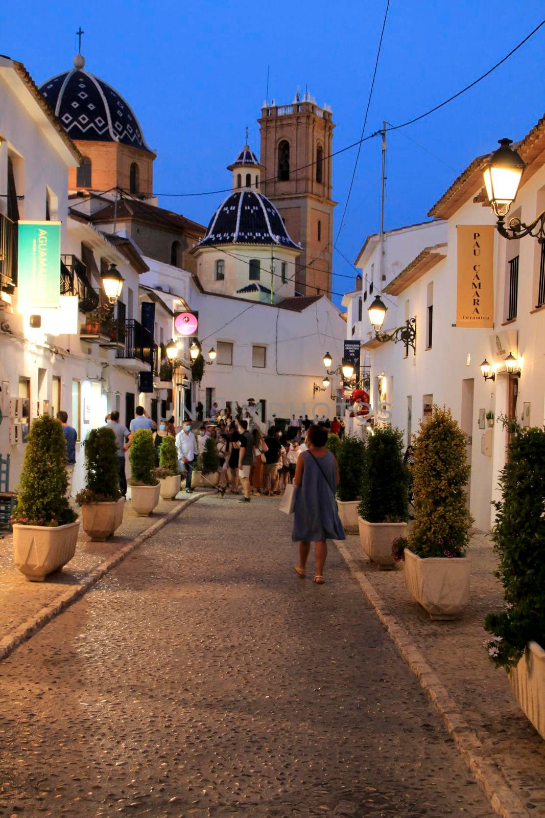 Altea, Alicante, Spain- June 12, 2021: People going shopping, walking and relaxing at night through the Narrow streets of Altea village, Alicante, Spain