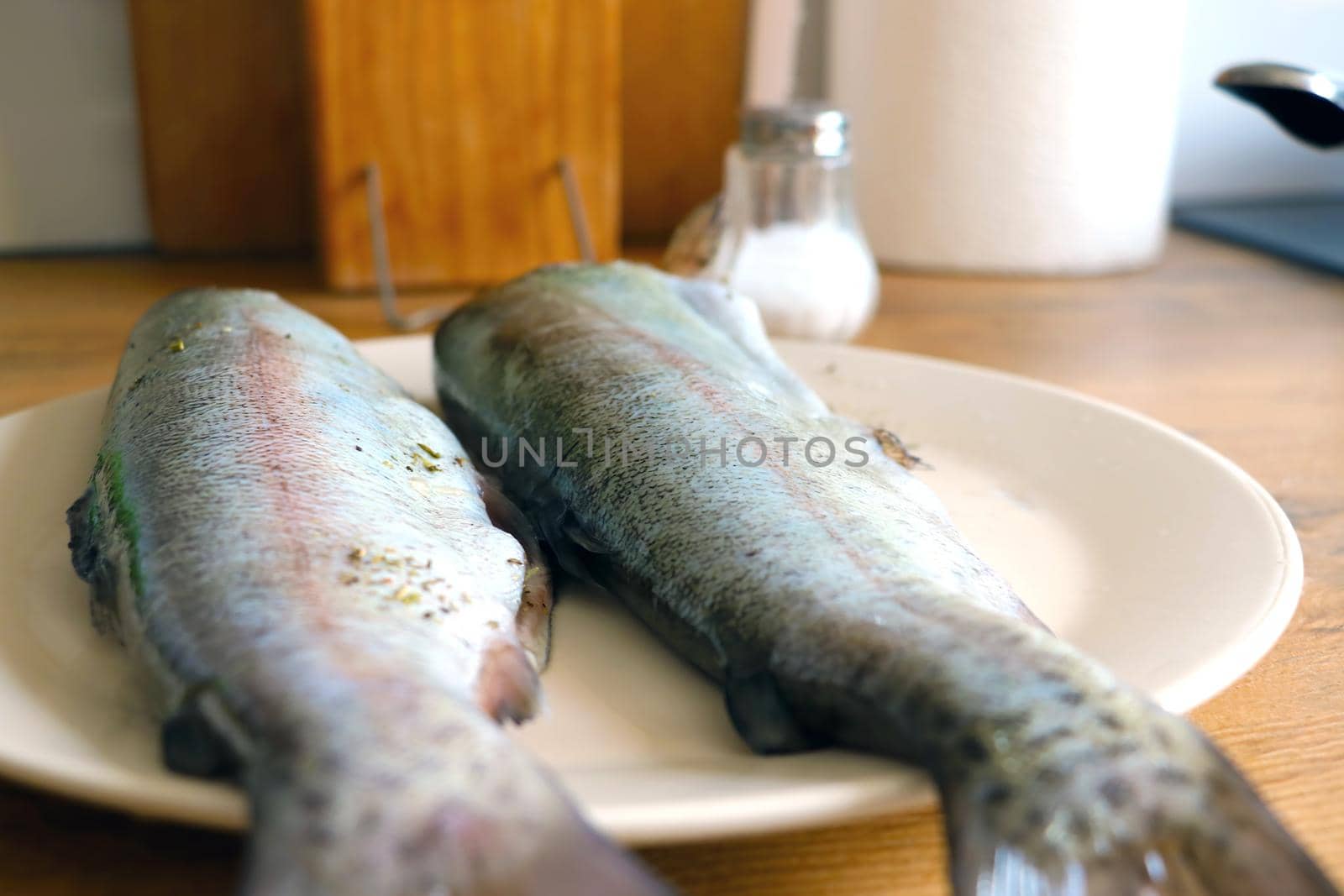 Two fish are in a plate. Cooking tasty and healthy fish for lunch