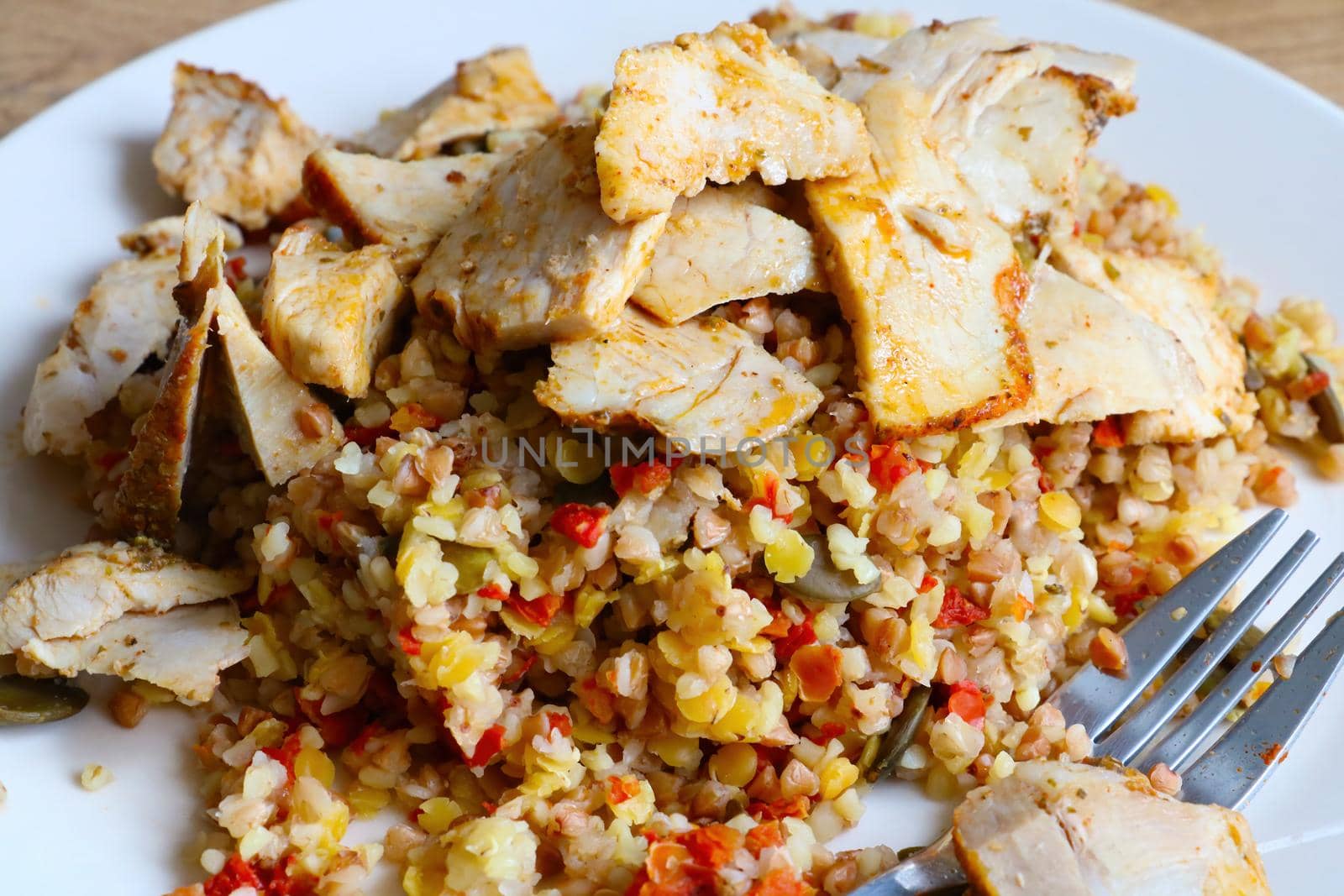 View of a plate with pieces of meat and healthy cereals. Healthy eating