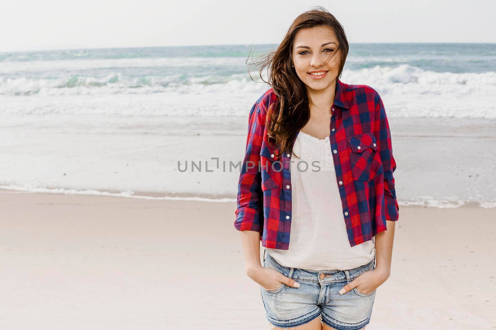 Beautiful and happy teen at the beach enjoying the summer