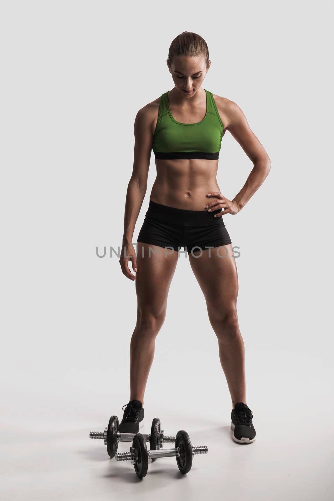 Studio portrait of a sporty young woman posing against a gray background