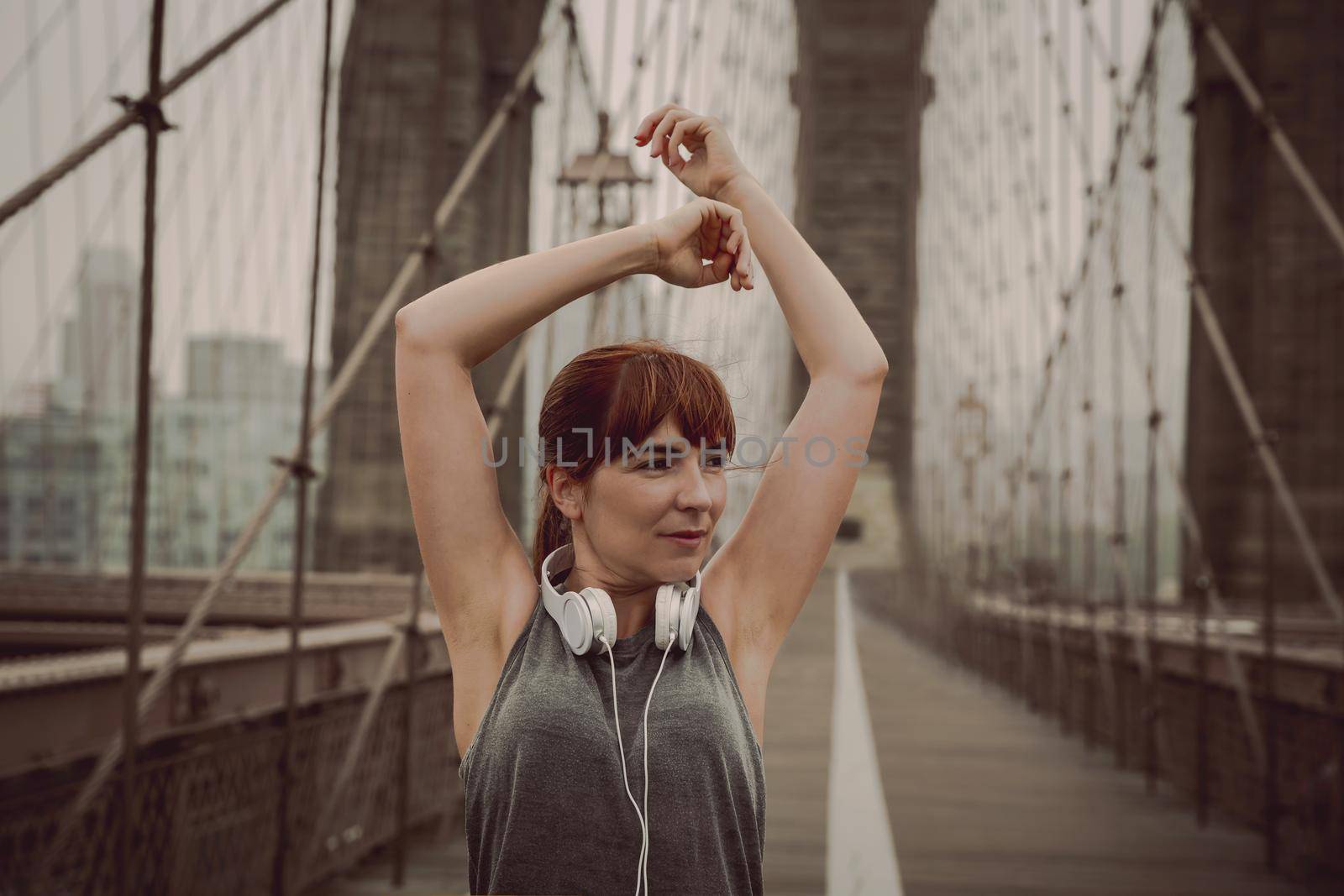 Woman on the Brooklyn bridge making a pause after the exercise