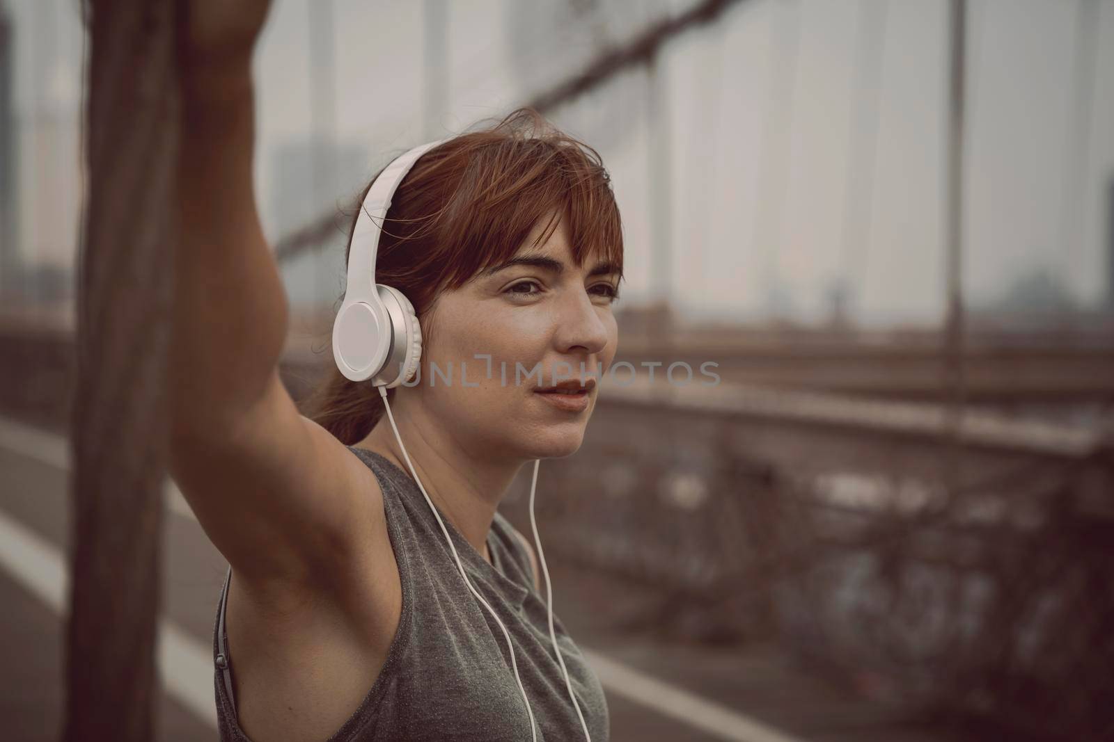 Woman on the Brooklyn bridge making a pause after the exercise