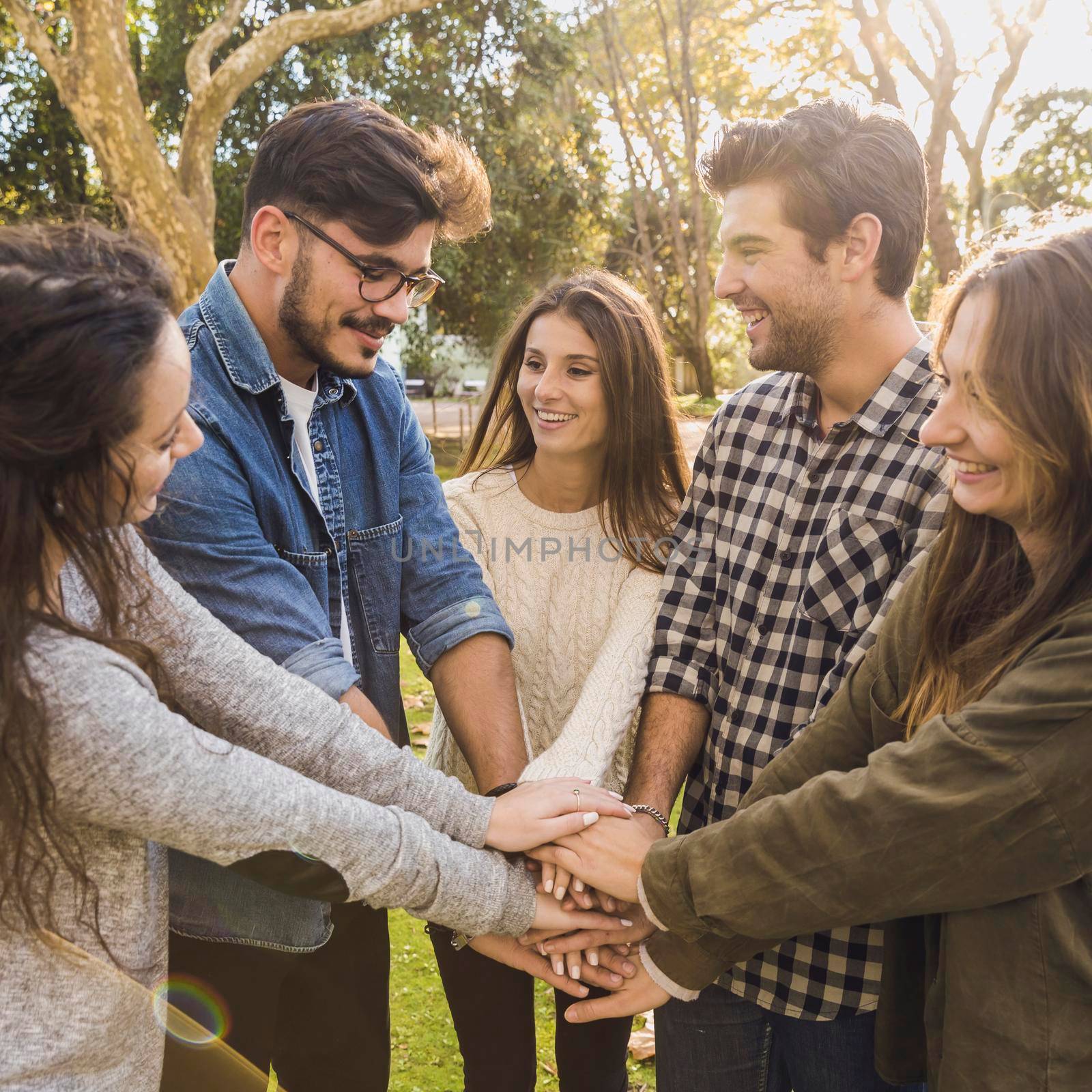 Group of friends joining their hands together