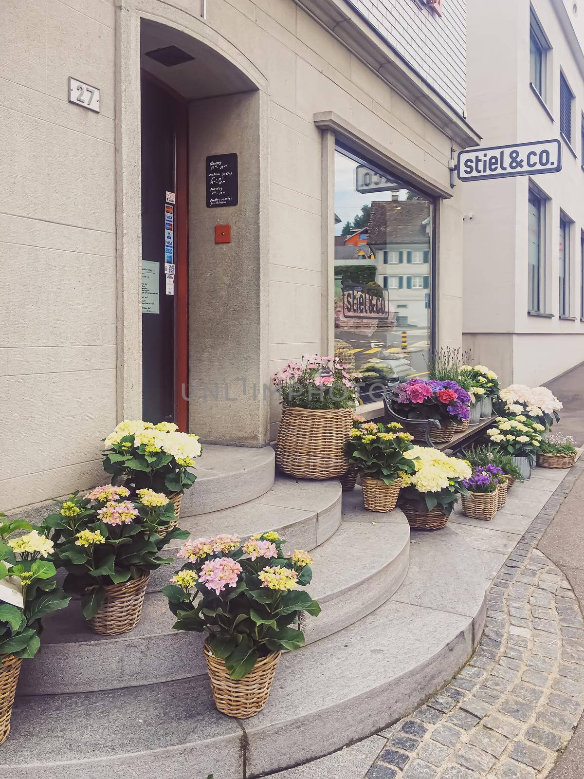 Flower shop on street of Wollerau, canton of Schwyz in Switzerland, Swiss architecture and real estate by Anneleven