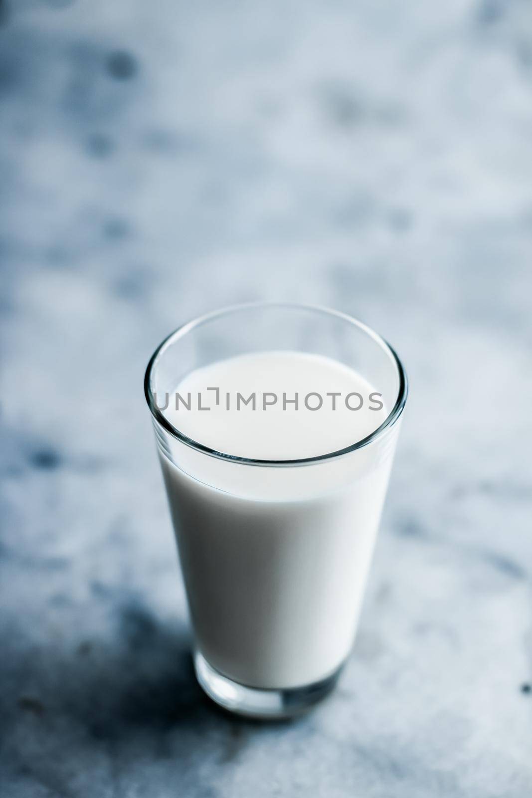 Dairy, healthy nutrition and breakfast concept - World Milk Day, full glass on marble table