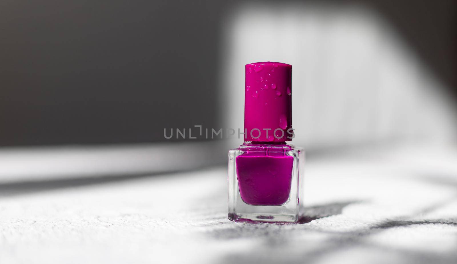Nail polish on a white background with shadows . The concept of nail polish without inscriptions. Light background and shadows. Copy space . Article about the choice of varnish. Cosmetology