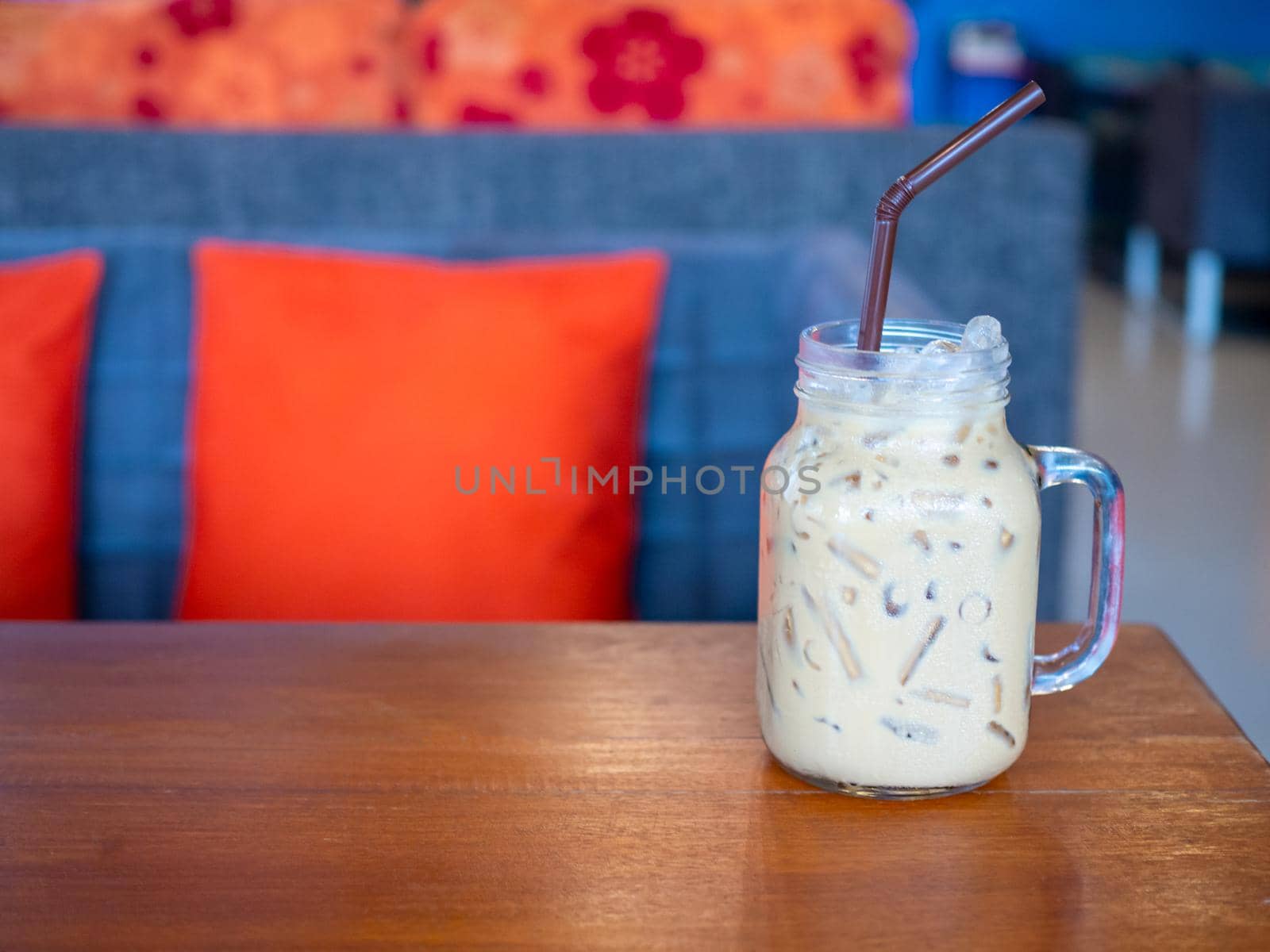 Fresh milk tea in a glass placed on a wooden floor. with free space