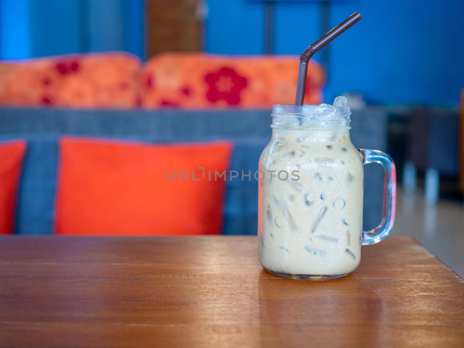 Fresh milk tea in a glass placed on a wooden floor. with free space by Unimages2527