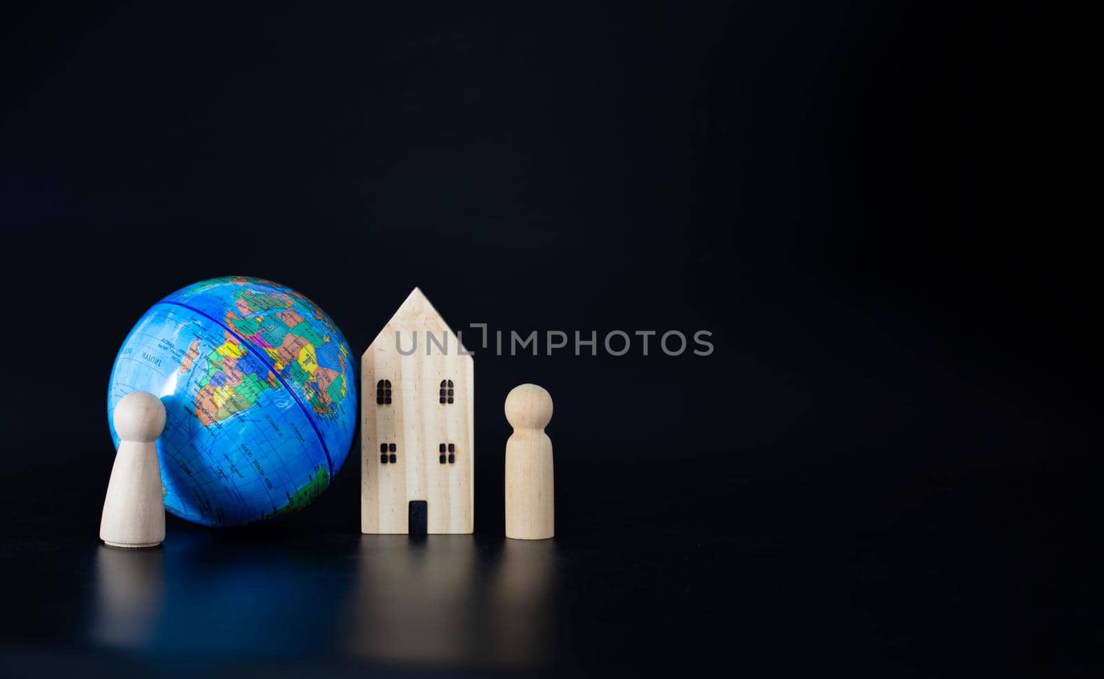 Model wooden houses and miniature globes Blank on a black background. Propose the concept of coexistence in the same world.