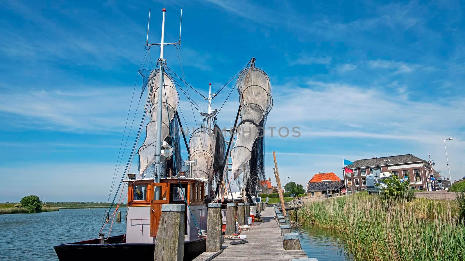 Old traditional fishing ship in the harbor from Workum in the Netherlands by devy