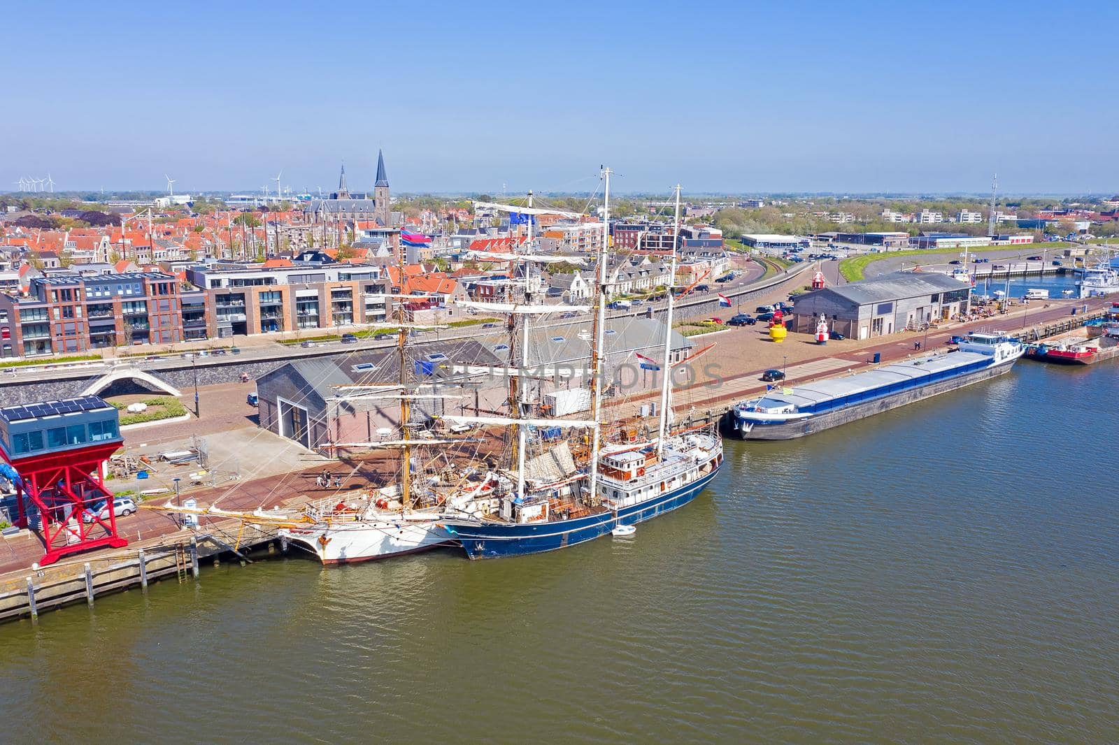 Aerial from the city Harlingen with traditional sailing ships in the Netherlands by devy