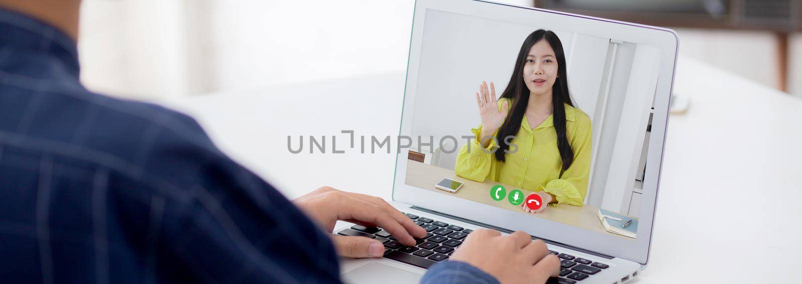 Young asian business man and woman video conference call online for discussion about statistics of finance with laptop computer, businesswoman explaining report with businessman, social distancing.
