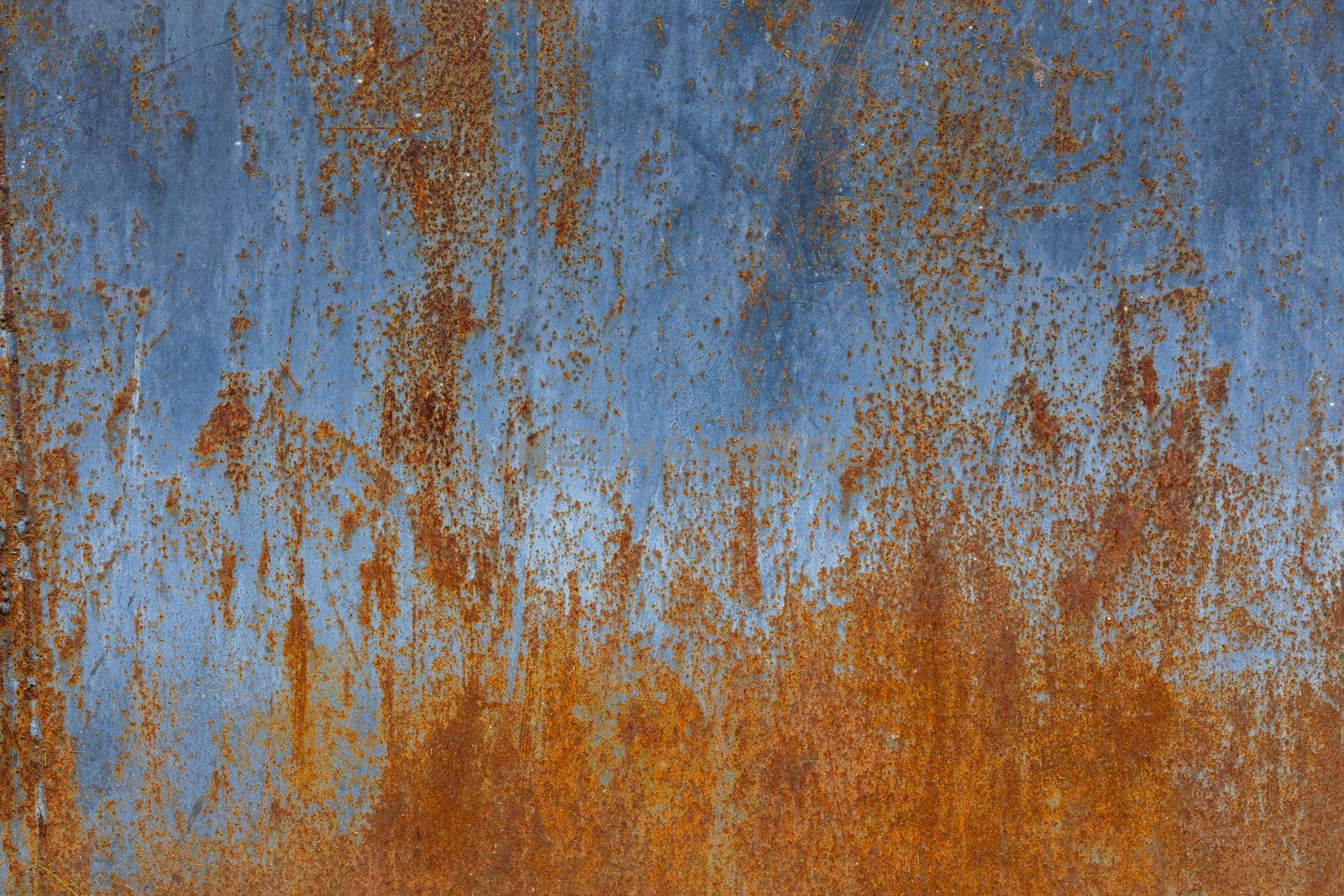 rusted flat solid sheet metal background and texture with leftovers of light-blue paint