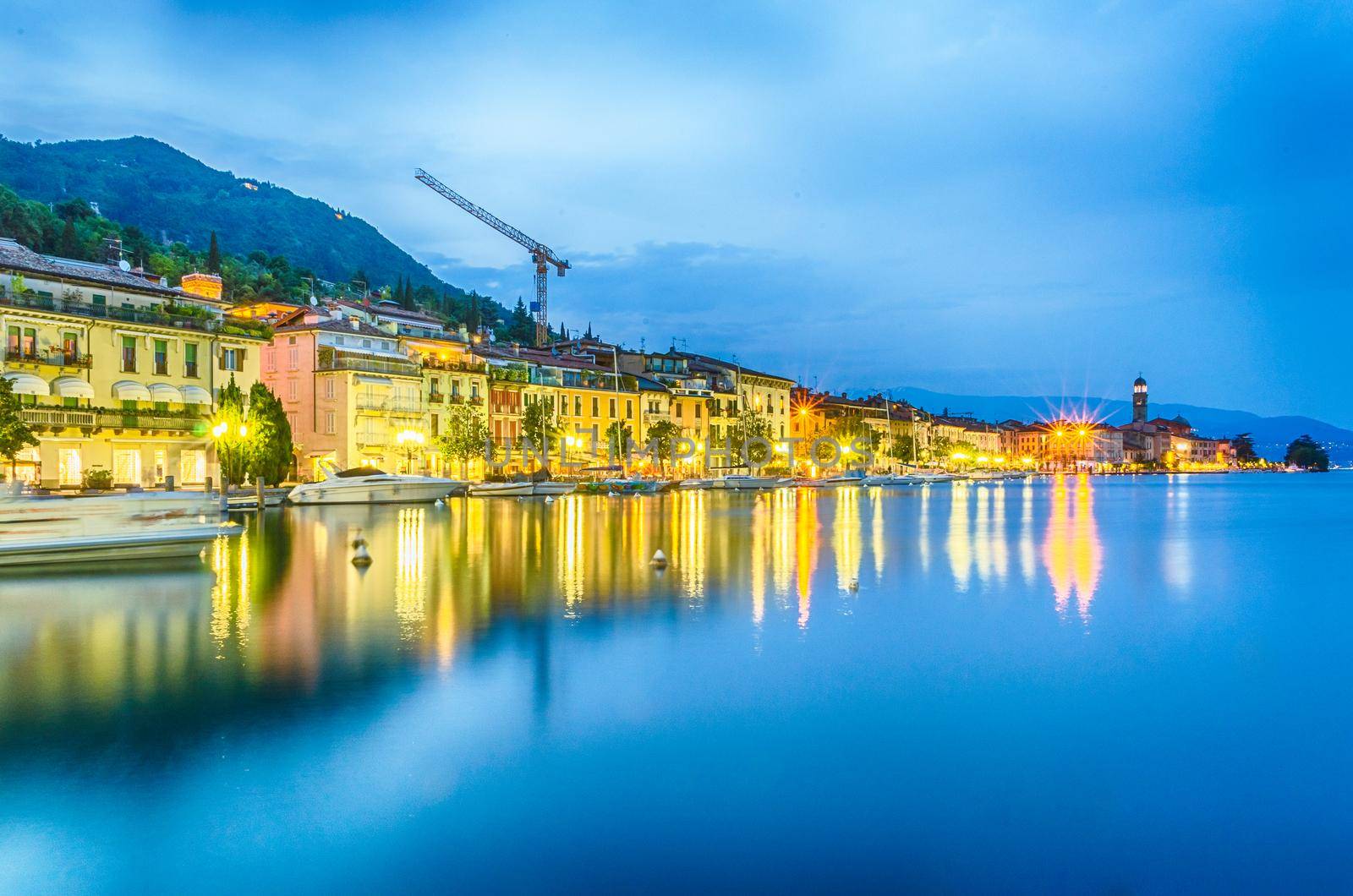 Scenic view of the waterfront in the town of Salo at night, Lake Garda, Italy