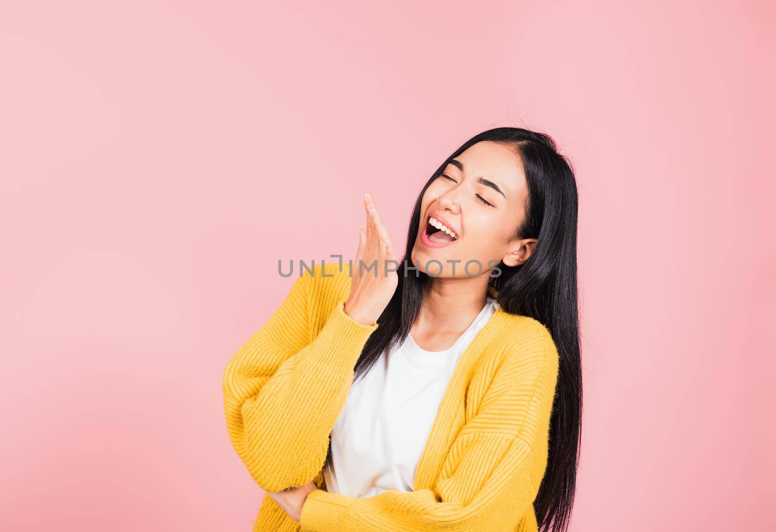 Happy Asian portrait beautiful cute young woman standing winning and surprised excited screaming laugh hand cover mouth, studio shot isolated pink background, Thai female wow scream with copy space