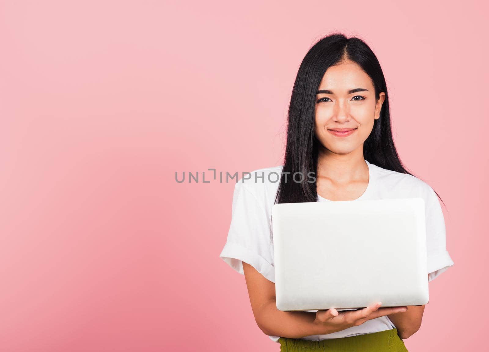 woman confident smiling face holding using laptop computer by Sorapop