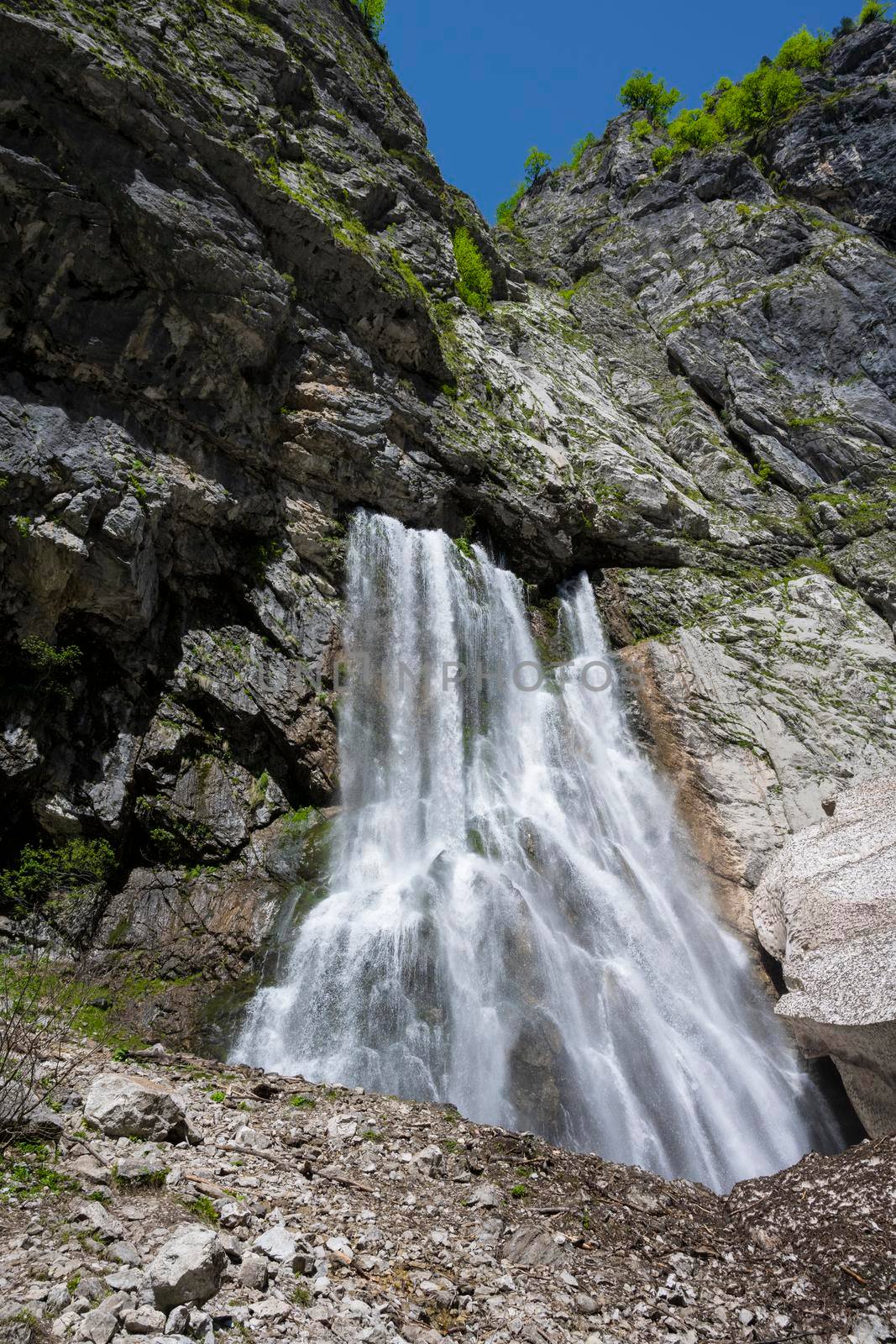 Geghsky waterfall in the mountains of the Republic of Abkhazia. Clear sunny day May 14, 2021.