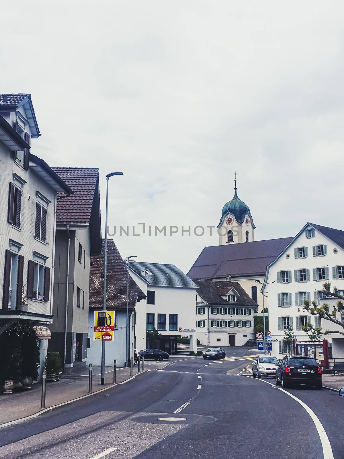 Historic buildings, church and houses on street of Wollerau, canton of Schwyz in Switzerland, Swiss architecture and real estate by Anneleven