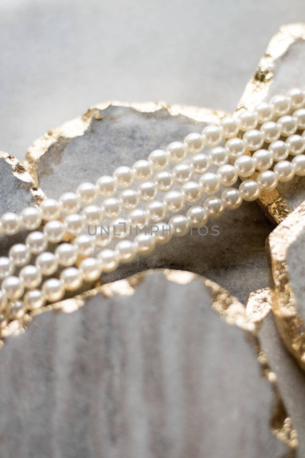 Pearl necklace on golden marble, ethical jewellery - luxury background, jewelry as a gift concept. Pearls are girl's best friends