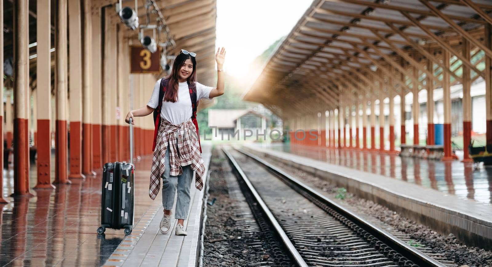 Portrait traveler assian woman walking and waits train on railway platform. by nateemee