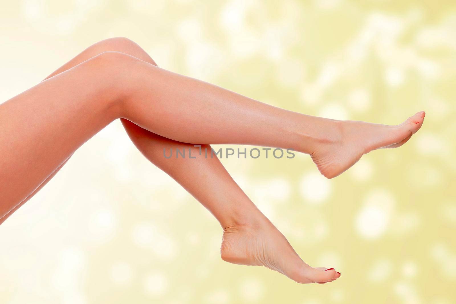 Long female legs on an abstract background. Skin care concept