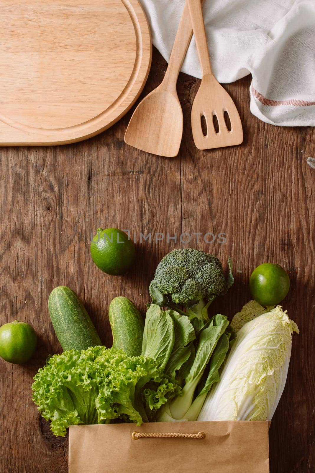 top view of green vegetables in shopping bag on wooden table by makidotvn