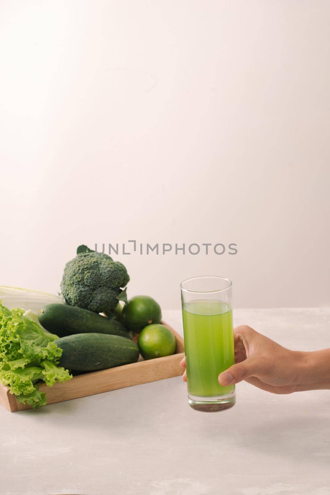 Vegan diet food. Detox drinks. Freshly squeezed juices and smoothies from vegetables. On white background, wooden tray, ingredients. Copy space by makidotvn