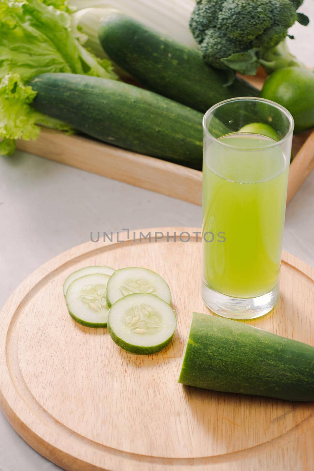 Vegan diet food. Detox drinks. Freshly squeezed juices and smoothies from vegetables. On white background, wooden tray, ingredients. Copy space