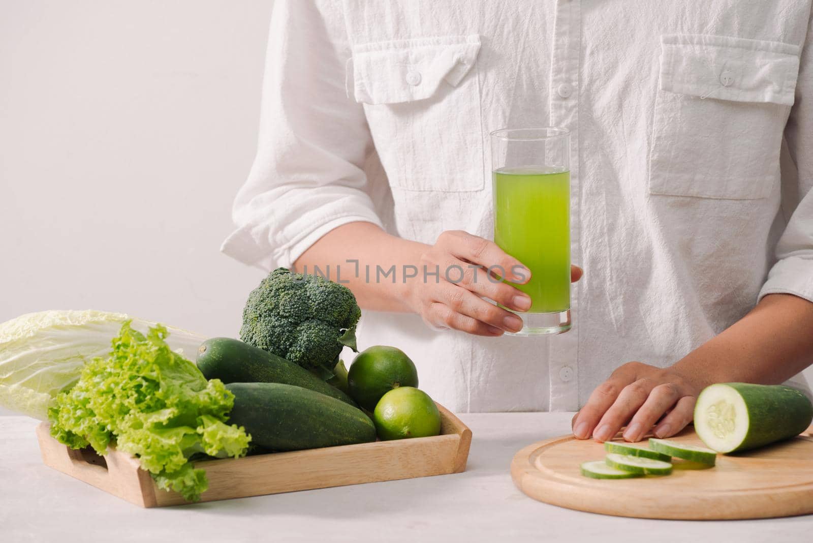 Market. Healthy vegan food. Fresh vegetables, berries, greens and fruits in wooden tray: cucumbers radish green peas ... white table. In man"s hands copy space