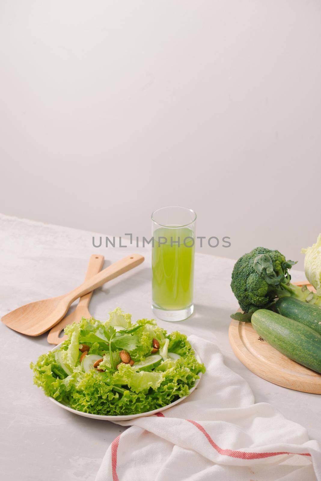 Various green organic salad ingredients on white background. Healthy lifestyle or detox diet food concept by makidotvn