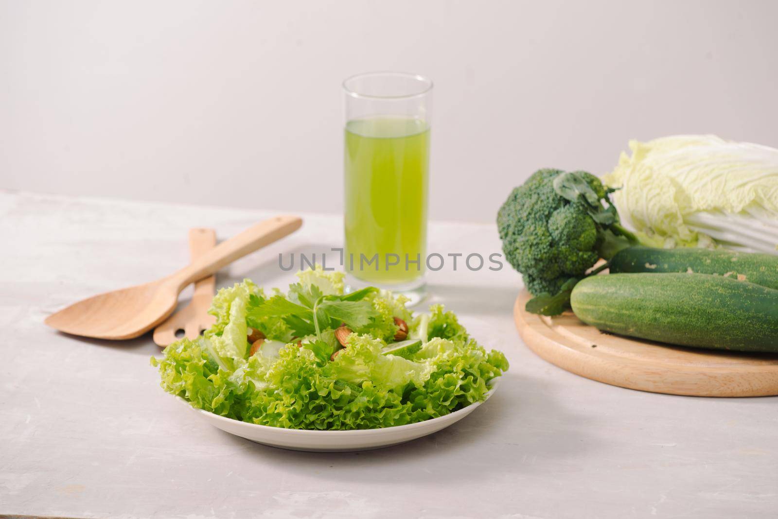 Various green organic salad ingredients on white background. Healthy lifestyle or detox diet food concept by makidotvn
