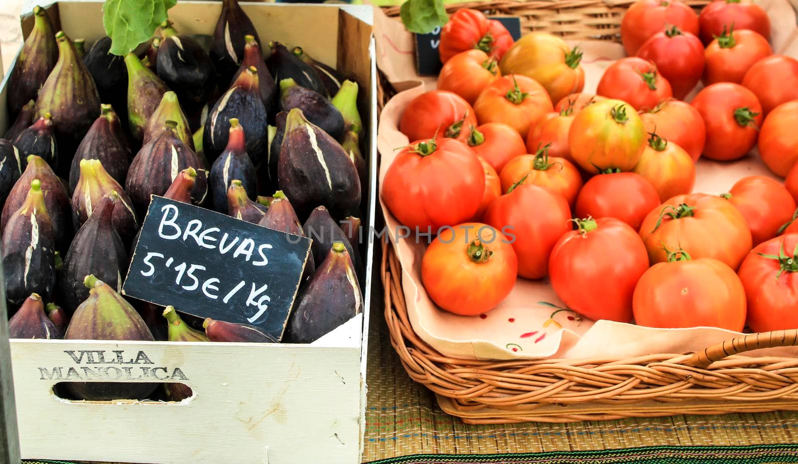 Elche, Alicante, Spain- January 26, 2021: Figs and tomatoes for sale at an ecological and sustainable market held in the countryside of Elche