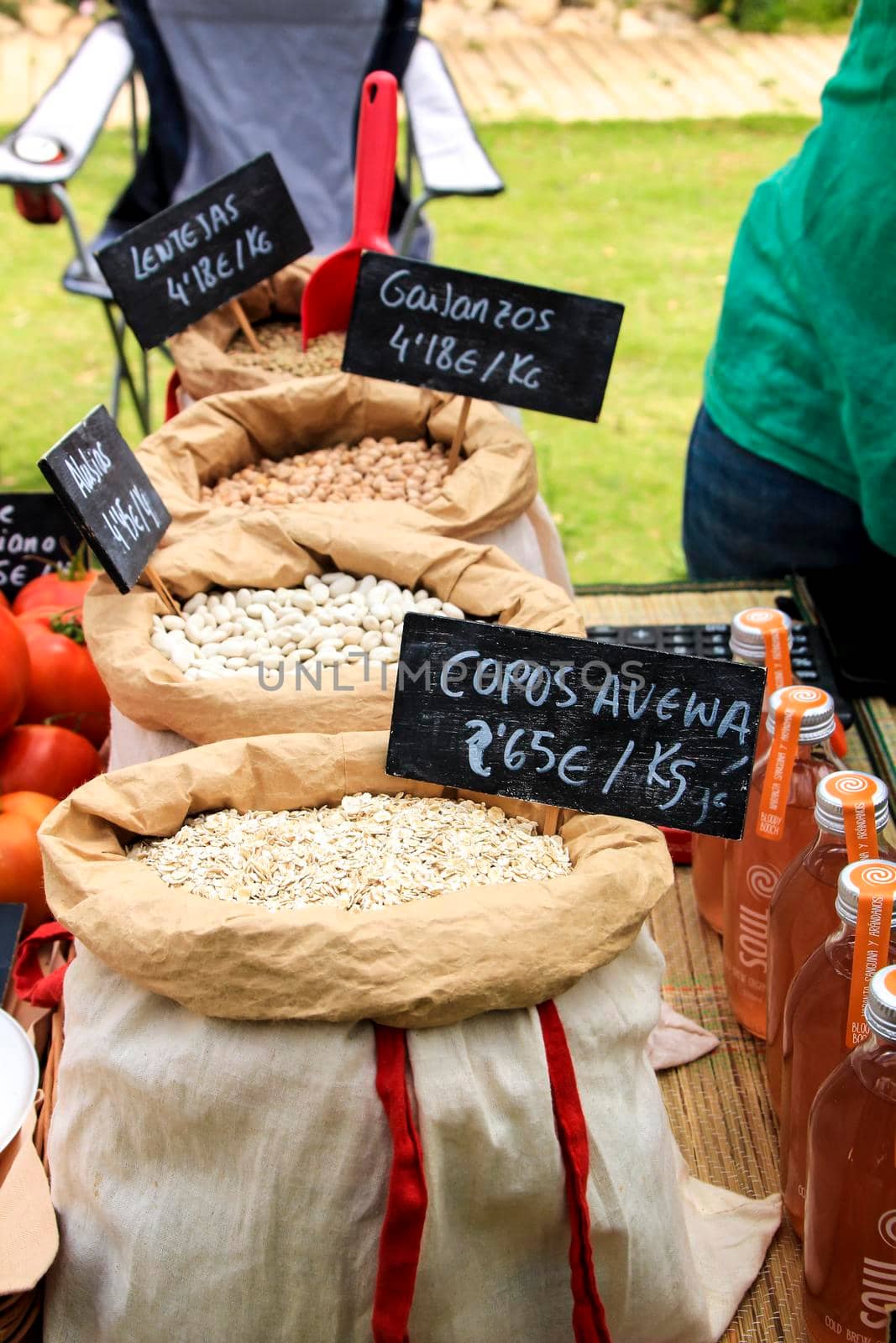 Elche, Alicante, Spain- June 20, 2021: Oat flakes, legumes and other organic products for sale at an ecological and sustainable market in Elche