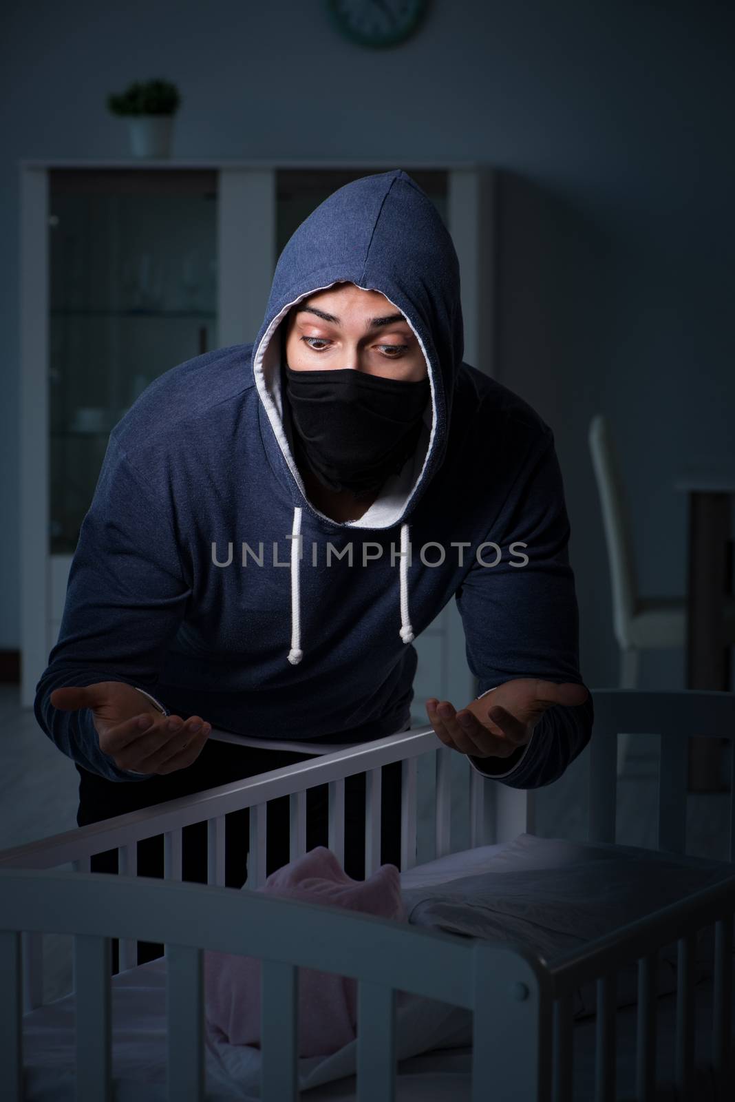Criminal stealing baby in human child traficking concept