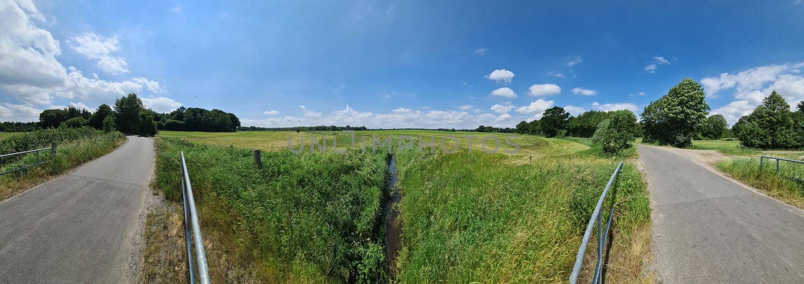 Panorama of countryside roads with fields and trees in northern europe.