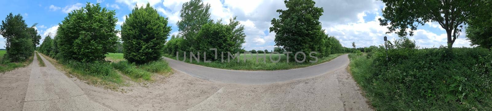 Panorama of countryside roads with fields and trees in northern europe.